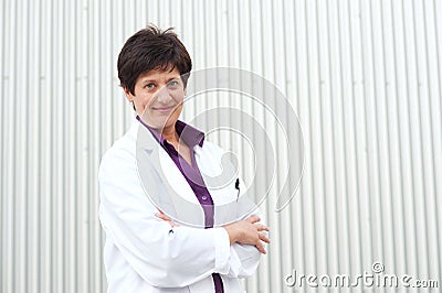 Smiling mature professional woman in labcoat