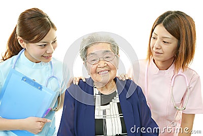 Smiling medical staff with old woman