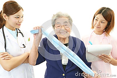 Smiling medical staff with old woman