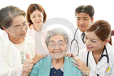 Smiling medical staff with old women