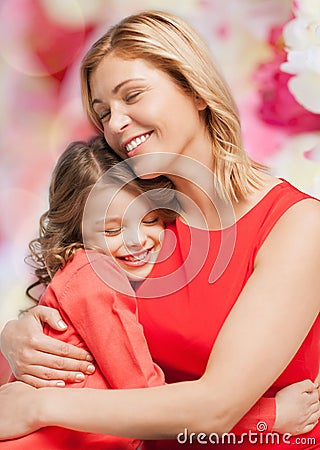 Smiling mother and daughter hugging