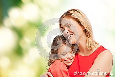 Smiling mother and daughter hugging