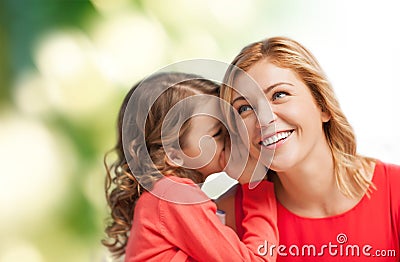 Smiling mother and daughter whispering gossip