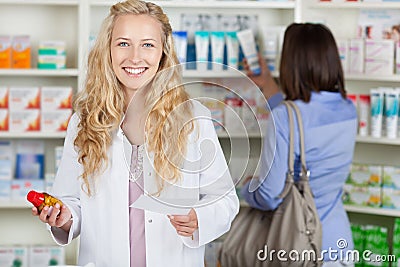 Smiling Pharmacist With Prescription Paper