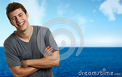 Smiling relaxed man at the beach in a summer day