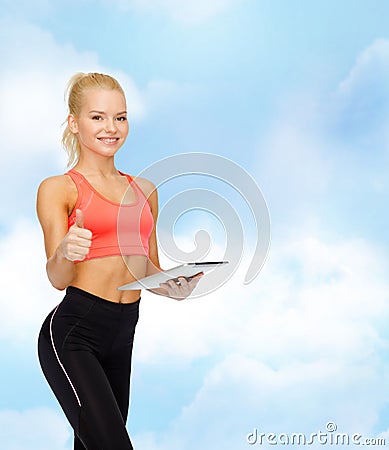 Smiling sporty woman with tablet pc computer