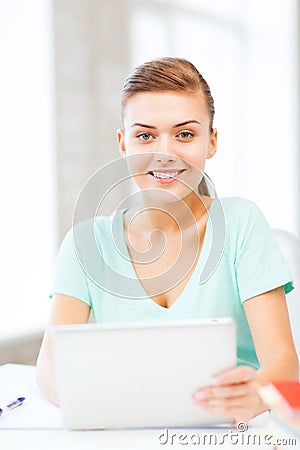 Smiling student girl with tablet pc