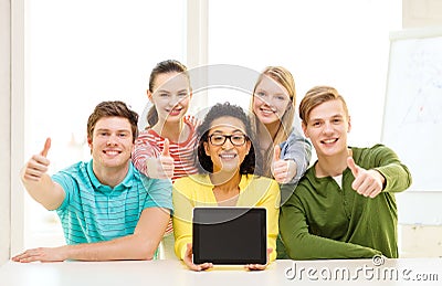Smiling students showing tablet pc blank screen