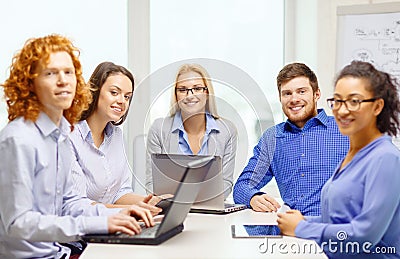 Smiling team with laptop and table pc computers