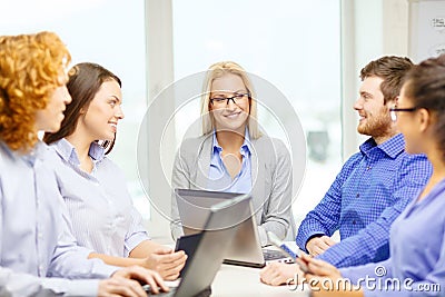 Smiling team with laptop and table pc computers