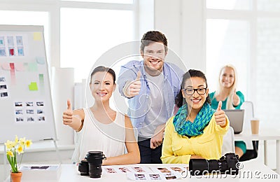 Smiling team with photocamera in office