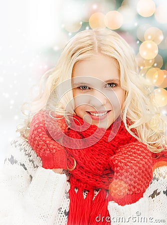 Smiling teenage girl in red mittens and scarf