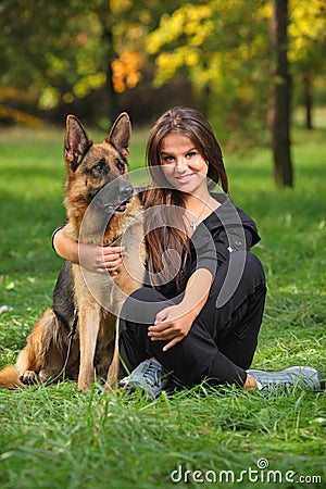 Smiling teenager hugging a dog