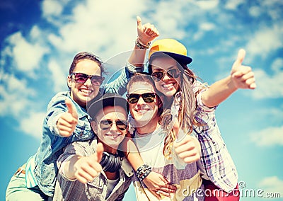 Smiling teenagers in sunglasses hanging outside