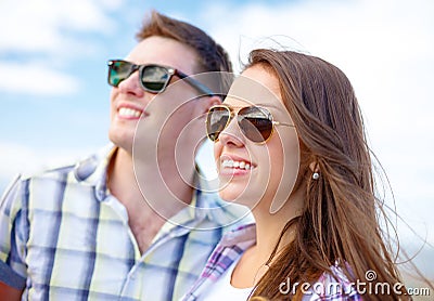 Smiling teenagers in sunglasses having fun outside