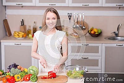 Smiling woman cooking in kitchen