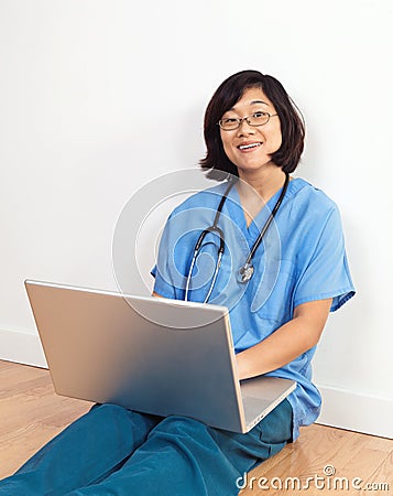 Smiling Woman Doctor or Nurse with Laptop Computer