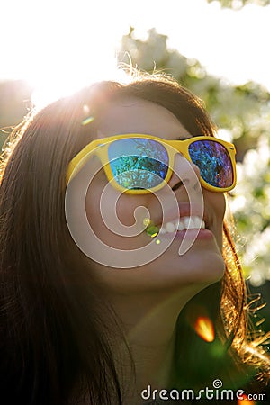 Smiling woman in fashionable sunglasses