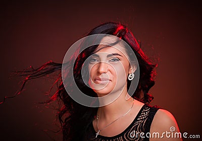 Smiling woman with hair blowing on wind