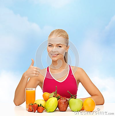 Smiling woman with organic food or fruits on table