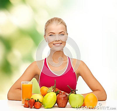 Smiling woman with organic food or fruits on table