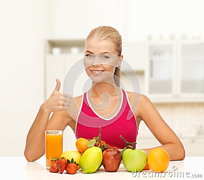 Smiling woman with organic food or fruits on table