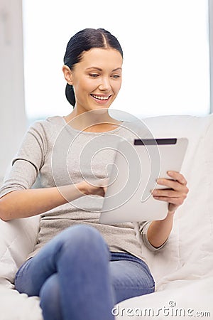 Smiling woman with tablet pc computer at home