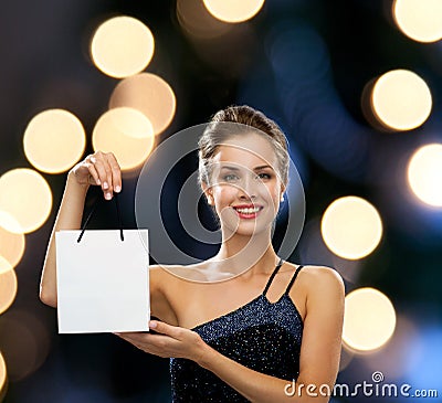 Smiling woman with white blank shopping bag