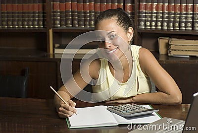 Smiling Woman Writes in Notebook - Horizontal