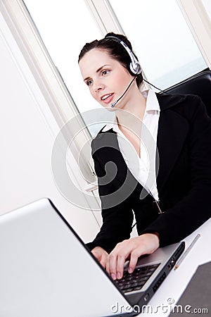 Smiling young female callcenter agent with headset