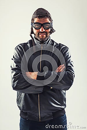 Smiling young man holding hands crossed