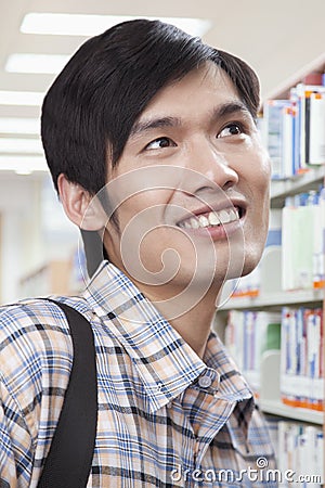 Smiling Young Man in Library Looking Away