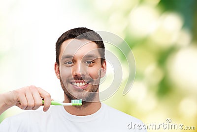 Smiling young man with toothbrush