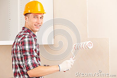 Smiling young painter with a roller