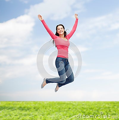 Smiling young woman jumping in air