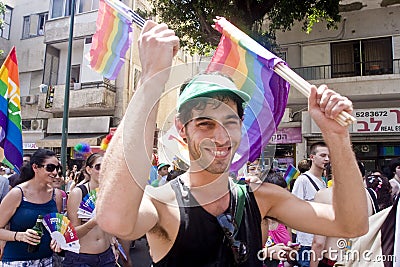 Smiling youth with rainbow flag at Pride Parade TA