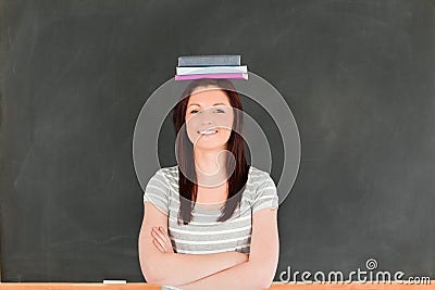 Smilling cute woman wearing books on her head