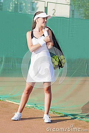 Smilling Female Tennis Woman Holding Tennis Mesh Bag with Balls
