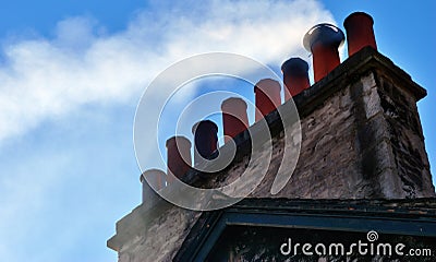 Smoking chimney stack on house