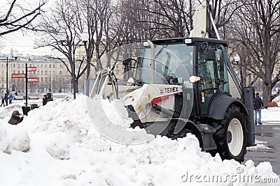 Snow blower cleans the street from snow