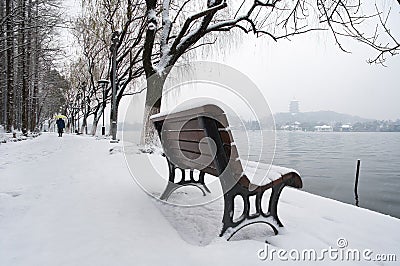 Snow-covered bench on the banks of West Lake, Hangzhou, China