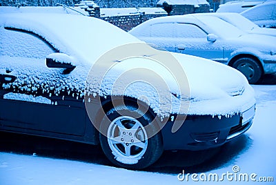 Snow-covered cars in the parking lot