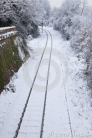 Snow Covered Railway Tracks and Stop Light