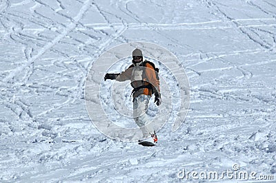 Snowboarder in powder snow with walkie-talkie