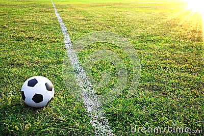 A soccer ball or football in stadium with sunset