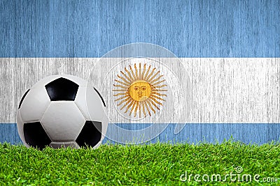 Soccer ball on grass with Argentina flag