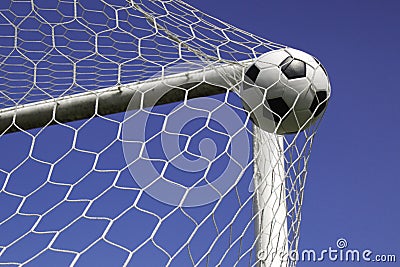 Soccer ball in net goal.