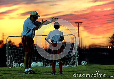 Soccer coaching at sunset