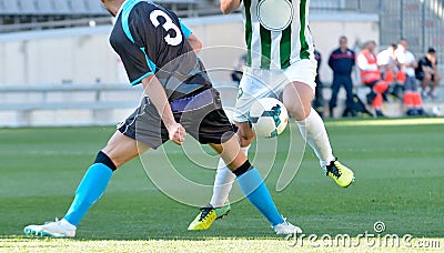 Soccer players playing the ball