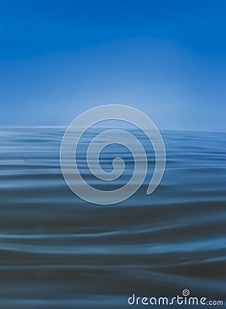 Soft blue waves on water surface, soft texture with infinite horizon